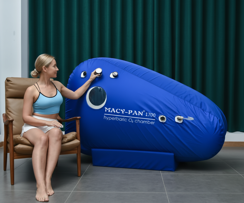 Woman interacting with a blue hyperbaric oxygen chamber labeled 'Macy-Pan 1700'
